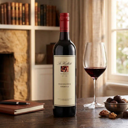 St. Hallett Old Block Shiraz wine bottle with a glass of wine on a wooden table.